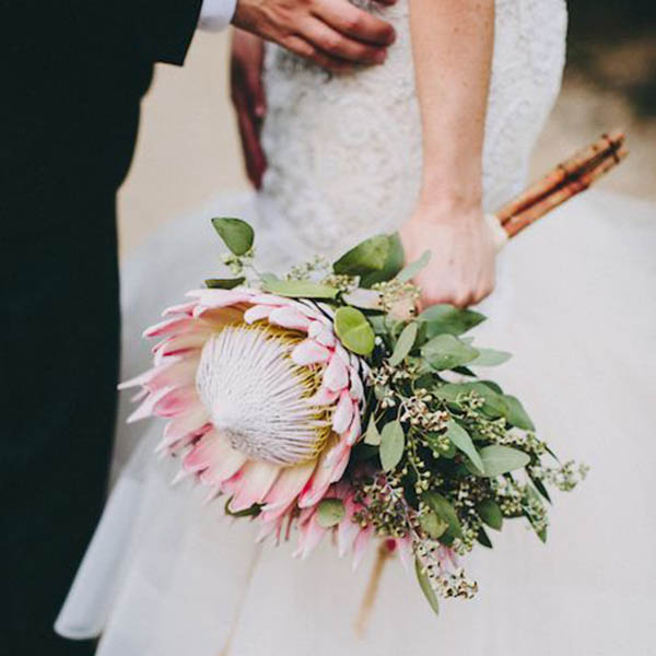 women holding a flower in hand