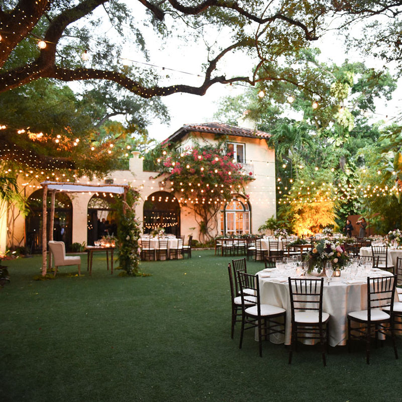 exterior of Villa Woodbine with tables and lights