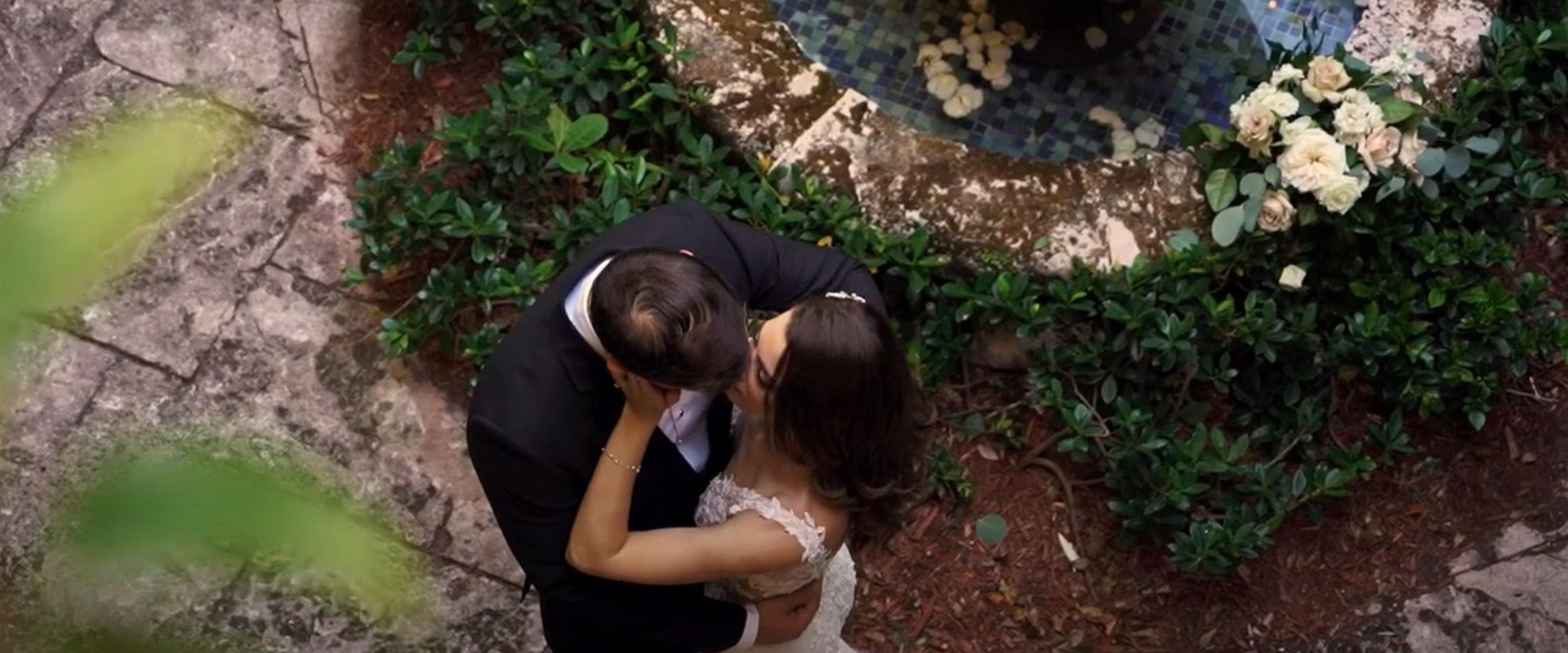 newlyweds kissing in courtyard